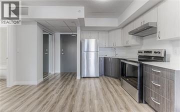 Cambridge apartment for rent - A modern kitchen with a stainless steel refrigerator and wooden flooring.