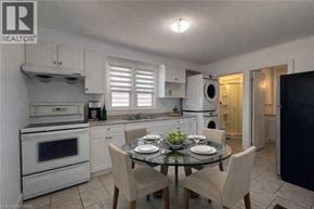 Kitchener apartment for rent - A well-lit kitchen with a dining table set for two.