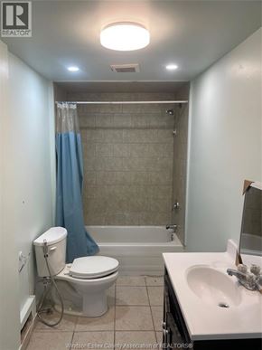 Windsor apartment for rent - A bathroom with a toilet, sink, and bathtub.