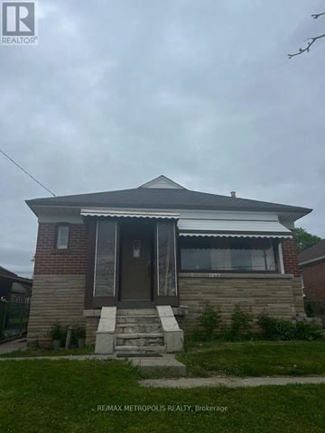 Toronto (Wexford-Maryvale) apartment for rent - A house with a brown door and a small porch.