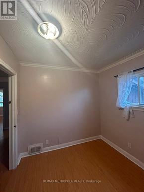 Toronto (Wexford-Maryvale) apartment for rent - A room with a ceiling light and a window with curtains.