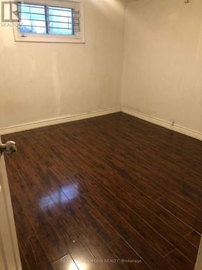 Toronto (Wexford-Maryvale) apartment for rent - A room with a wooden floor and a window.