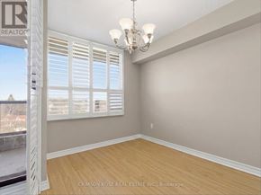 Ajax (Central West) condo for rent - A room with a chandelier and a window with shutters.