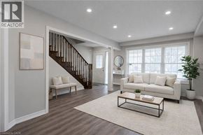 Brantford apartment for rent - A living room with a white couch, a coffee table, and a staircase.