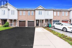 Mississauga (Churchill Meadows) townhouse for rent - A white car is parked in front of a brick house.
