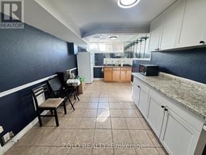 Hamilton (Jerome) apartment for rent - A kitchen with a blue wall and white cabinets.