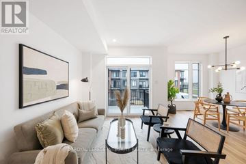 Ottawa townhouse for rent - A living room with a grey sofa and a glass coffee table.