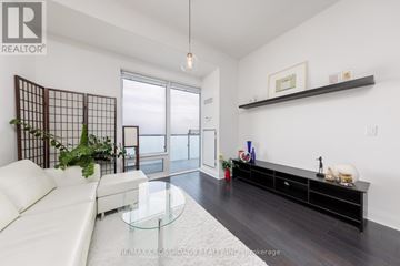 Toronto (Bay Street Corridor) condo for rent - A living room with a white sofa and a glass coffee table.