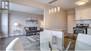 Toronto (Wexford-Maryvale) townhouse for rent - A modern kitchen and living room with a glass table and white chairs.