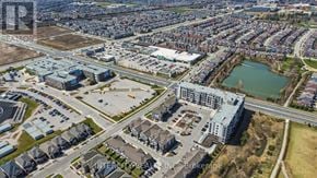 Milton (Fo Ford) condo for rent - An aerial view of a city with a mix of residential and commercial buildings.