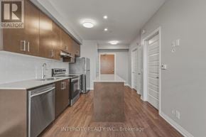 Milton (Fo Ford) condo for rent - A kitchen with stainless steel appliances and wooden cabinets.