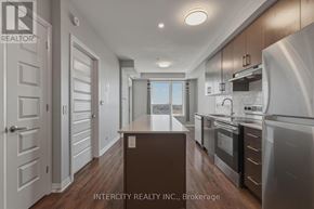 Milton (Fo Ford) condo for rent - A modern kitchen with stainless steel appliances and wooden floors.
