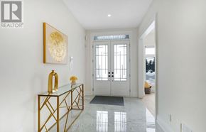 Brampton (Bram West) apartment for rent - A hallway with a glass table and a gold framed picture on the wall.