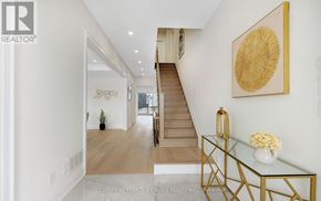 Brampton (Bram West) apartment for rent - A hallway with a staircase and a glass table with flowers on it.