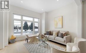 Brampton (Bram West) apartment for rent - A living room with a large window and a view of a snowy landscape.