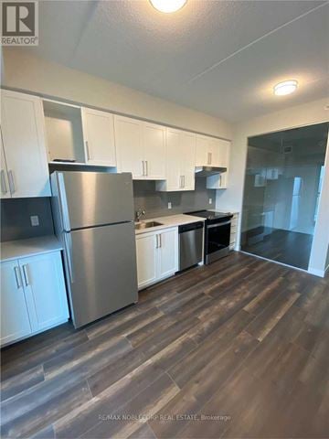 Hamilton (Central) house for rent - A kitchen with white cabinets and a stainless steel refrigerator.
