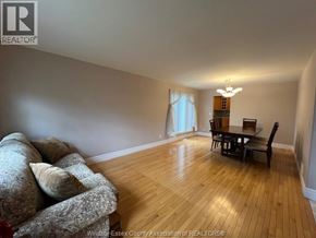 Windsor apartment for rent - A living room with a couch, a chair, and a dining table.
