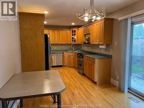 Windsor apartment for rent - A kitchen with wooden cabinets and a table.