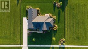 Norwich (Otterville) apartment for rent - A house with a grey roof is surrounded by a well-maintained lawn.
