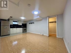 Toronto (Willowdale East) apartment for rent - A well-lit, empty room with wooden flooring and white walls.
