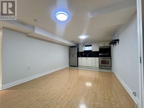 Toronto (Willowdale East) apartment for rent - A spacious kitchen with wooden flooring and white walls.