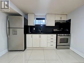 Toronto (Willowdale East) apartment for rent - A kitchen with white cabinets and a stainless steel refrigerator.