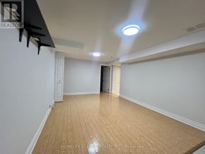 Toronto (Willowdale East) apartment for rent - A room with wooden flooring and white walls, with a light on the ceiling.