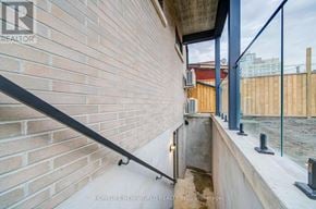 Toronto (Little Portugal) multi-family for rent - A balcony with a brick wall and a metal railing.