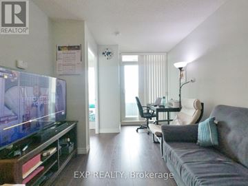 Toronto (Bayview Village) condo for rent - A living room with a grey couch and a flat screen TV.