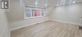 Richmond Hill (Mill Pond) apartment for rent - A room with a window showing a view of a red building outside.