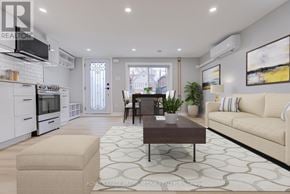 Toronto (Long Branch) fourplex for rent - A well-lit, modern kitchen with a dining area in the background.