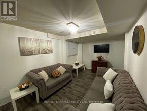 Mississauga (East Credit) apartment for rent - A living room with a grey couch and a white coffee table.