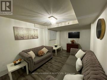 Mississauga (East Credit) apartment for rent - A living room with a grey couch and a white coffee table.
