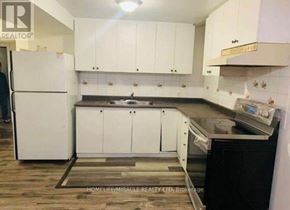 Mississauga (East Credit) apartment for rent - A kitchen with white cabinets and a white refrigerator.