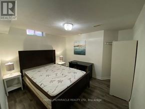 Mississauga (East Credit) apartment for rent - A bedroom with a bed, nightstand, and lamp.
