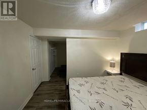 Mississauga (East Credit) apartment for rent - A bedroom with a bed, lamp, and a carpeted floor.