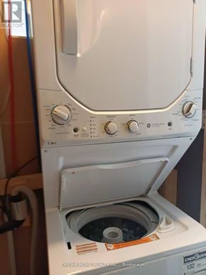Richmond Hill (Westbrook) apartment for rent - A white dryer with the door open is in front of a wall.