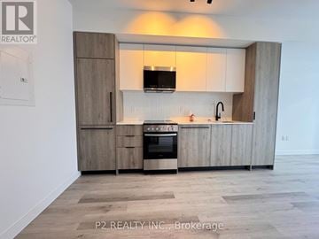 Toronto (Centennial Scarborough) condo for rent - A modern kitchen with wooden cabinets and a stainless steel oven.