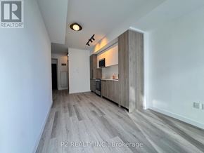 Toronto (Centennial Scarborough) condo for rent - A modern kitchen with a wooden floor and white walls.