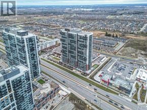 Oshawa (Windfields) condo for rent - A cityscape with apartment buildings and a highway.