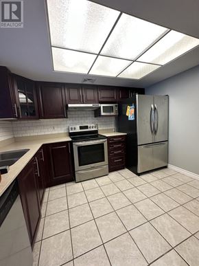 Toronto (Newtonbrook East) condo for rent - A kitchen with a refrigerator, oven, and microwave.