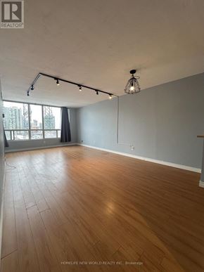 Toronto (Newtonbrook East) condo for rent - A room with wooden flooring and a large window.