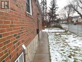 Toronto (Crescent Town) apartment for rent - A brick house with a snow covered ground.