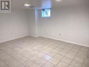 Toronto (Crescent Town) apartment for rent - A large empty room with a window and tiled floor.