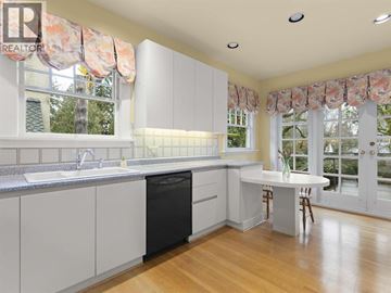 Vancouver apartment for rent - A kitchen with white cabinets and a black dishwasher.