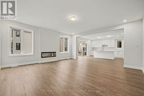Ottawa apartment for rent - A spacious room with wooden flooring and white walls.