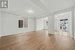 Ottawa apartment for rent - A spacious room with wooden flooring and white walls.