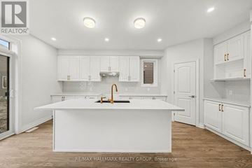 Ottawa apartment for rent - A white kitchen with a sink and cabinets.