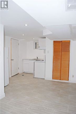 Toronto (Oakridge) apartment for rent - A kitchen with white cabinets and a white dishwasher.