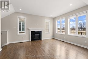 Ottawa apartment for rent - A spacious room with a fireplace and large windows.